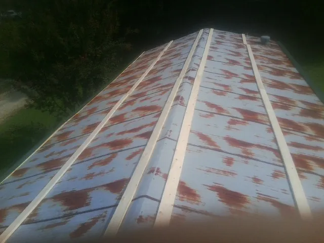 Rusted metal roof panels with new wood purlins before replacement — Storm Damage Roof Repair in Sugarloaf by Roofing Brothers